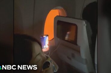 Video shows passengers stuck on burning plane in Japan