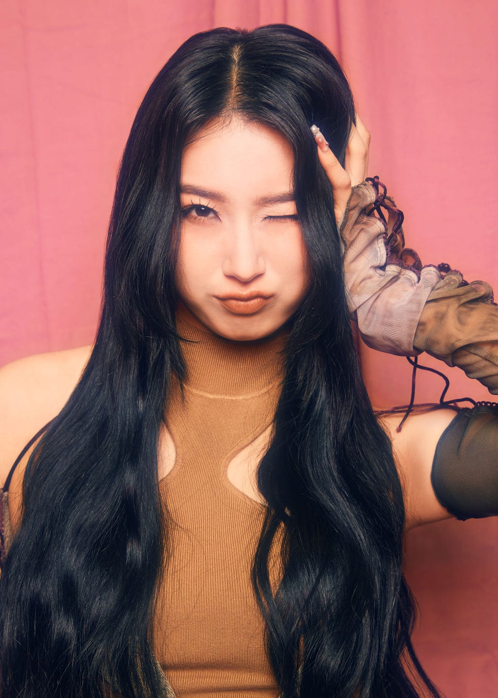portrait with a model featuring long black hair and unique clothing