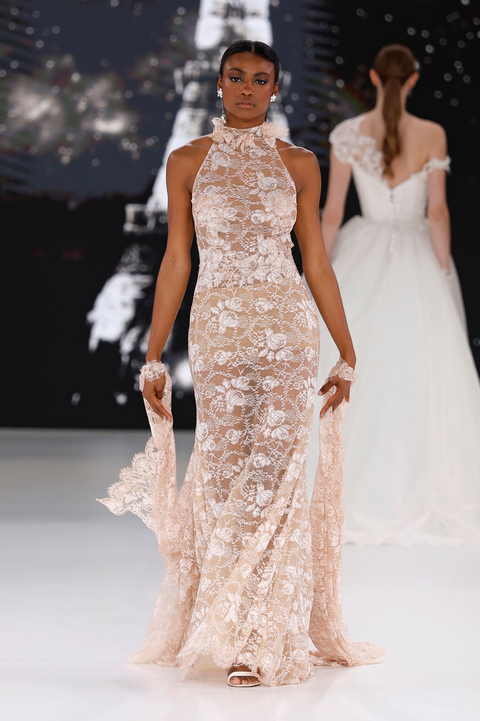 Image may contain Clothing Dress Fashion Formal Wear Gown Wedding Wedding Gown Adult and Person