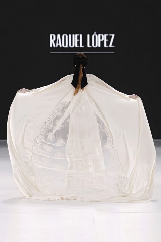 Image may contain Bag Bridal Veil Clothing Dress Fashion Formal Wear Gown Person Wedding and Wedding Gown