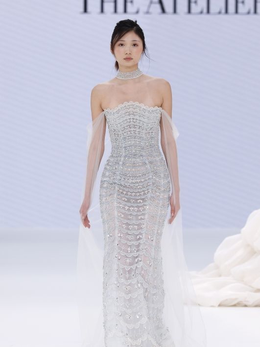 Image may contain Clothing Dress Formal Wear Fashion Gown Wedding Wedding Gown Evening Dress Adult and Person