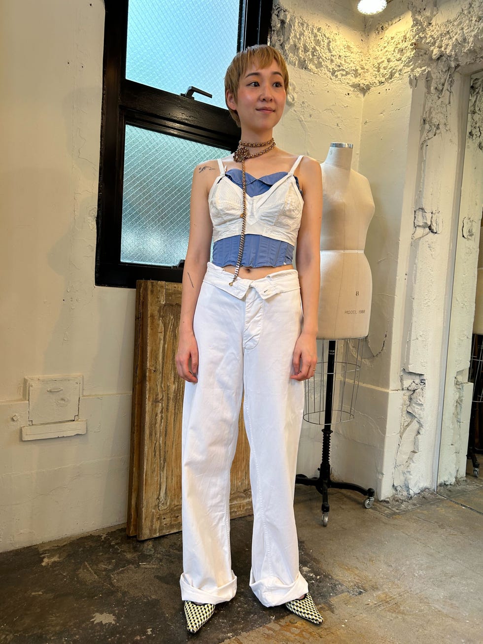 a person showcasing a unique fashion outfit in a studio setting a person showcasing a unique fashion outfit in a studio setting