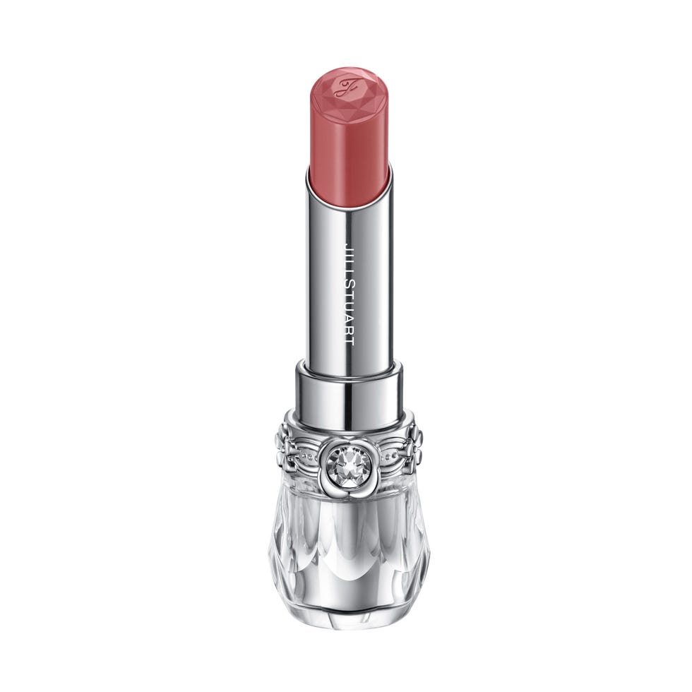 lipstick tube with a gemstone detail and a soft pink hue