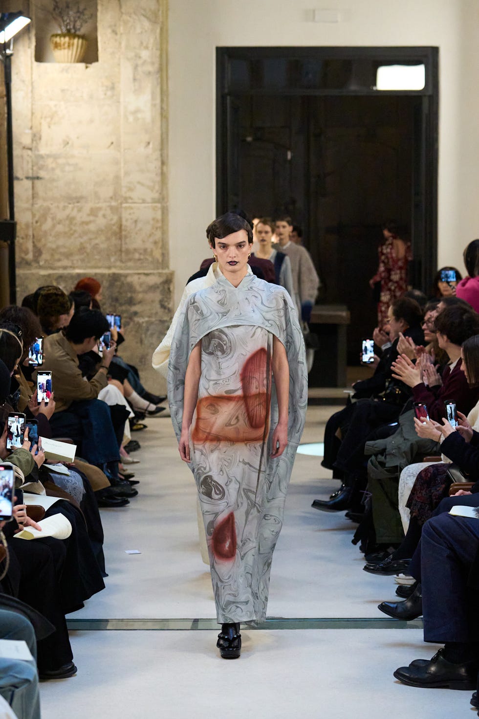 Runway event showcasing a model in a unique design