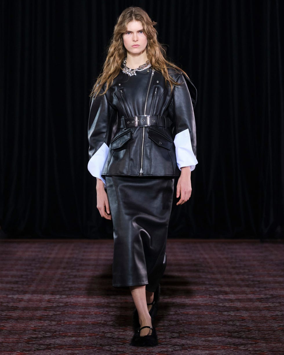model showcasing a stylish leather outfit at a fashion event