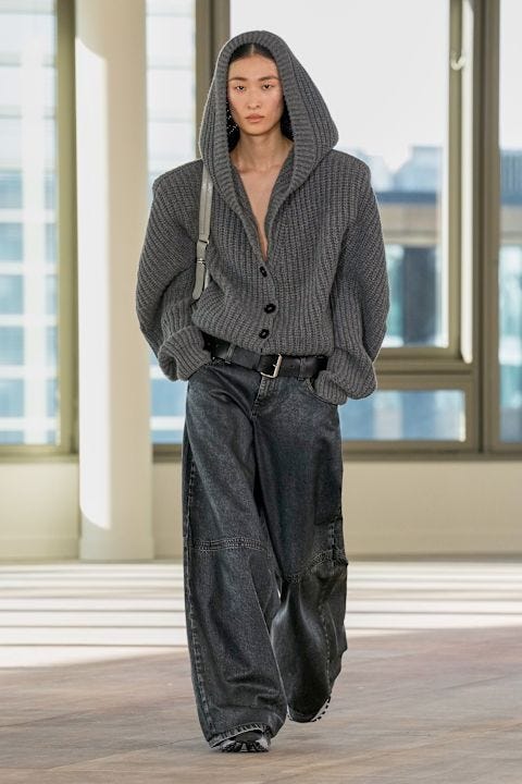 a model showcasing contemporary fashion in a modern setting
