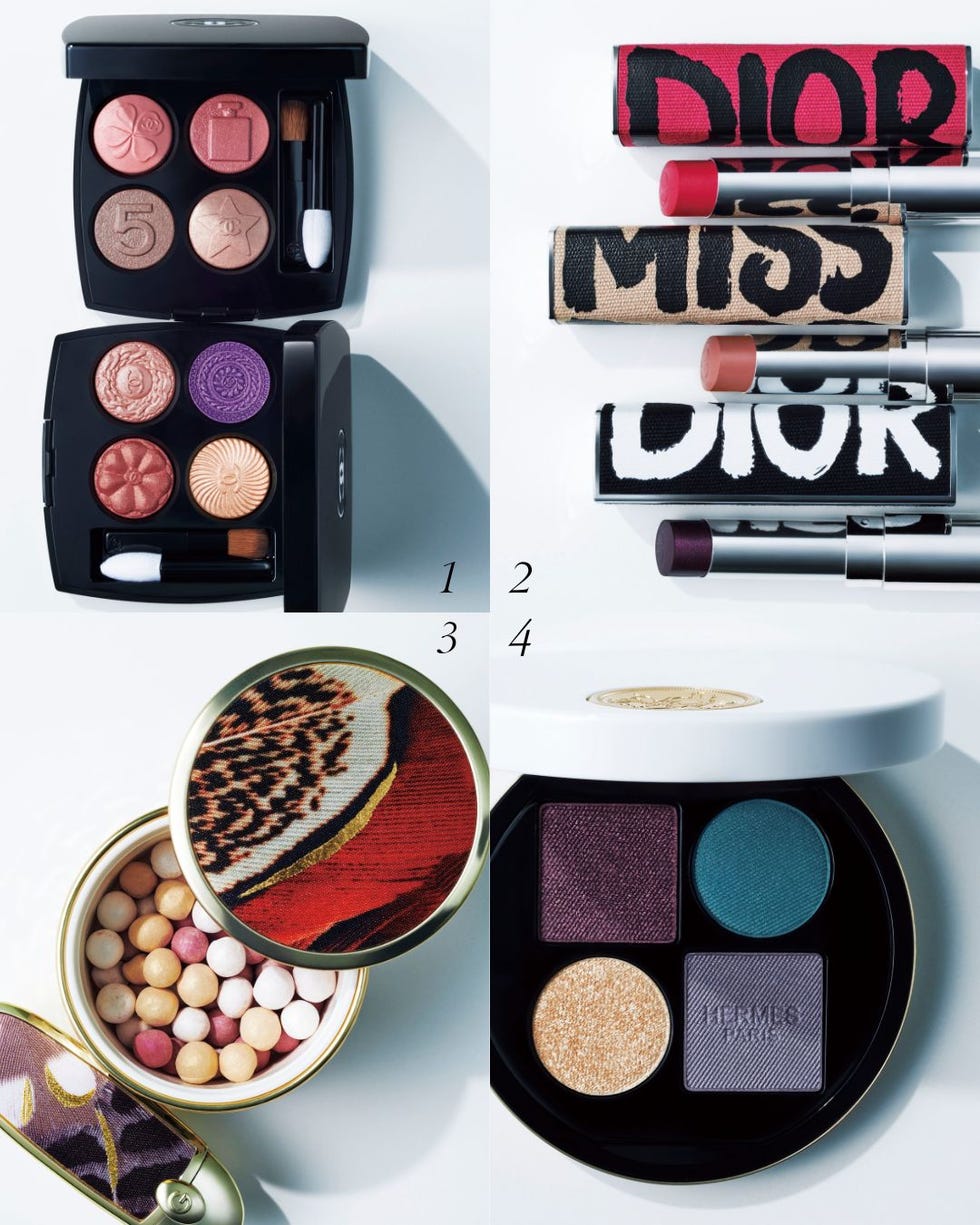 assortment of highend makeup products including eyeshadows and lipsticks