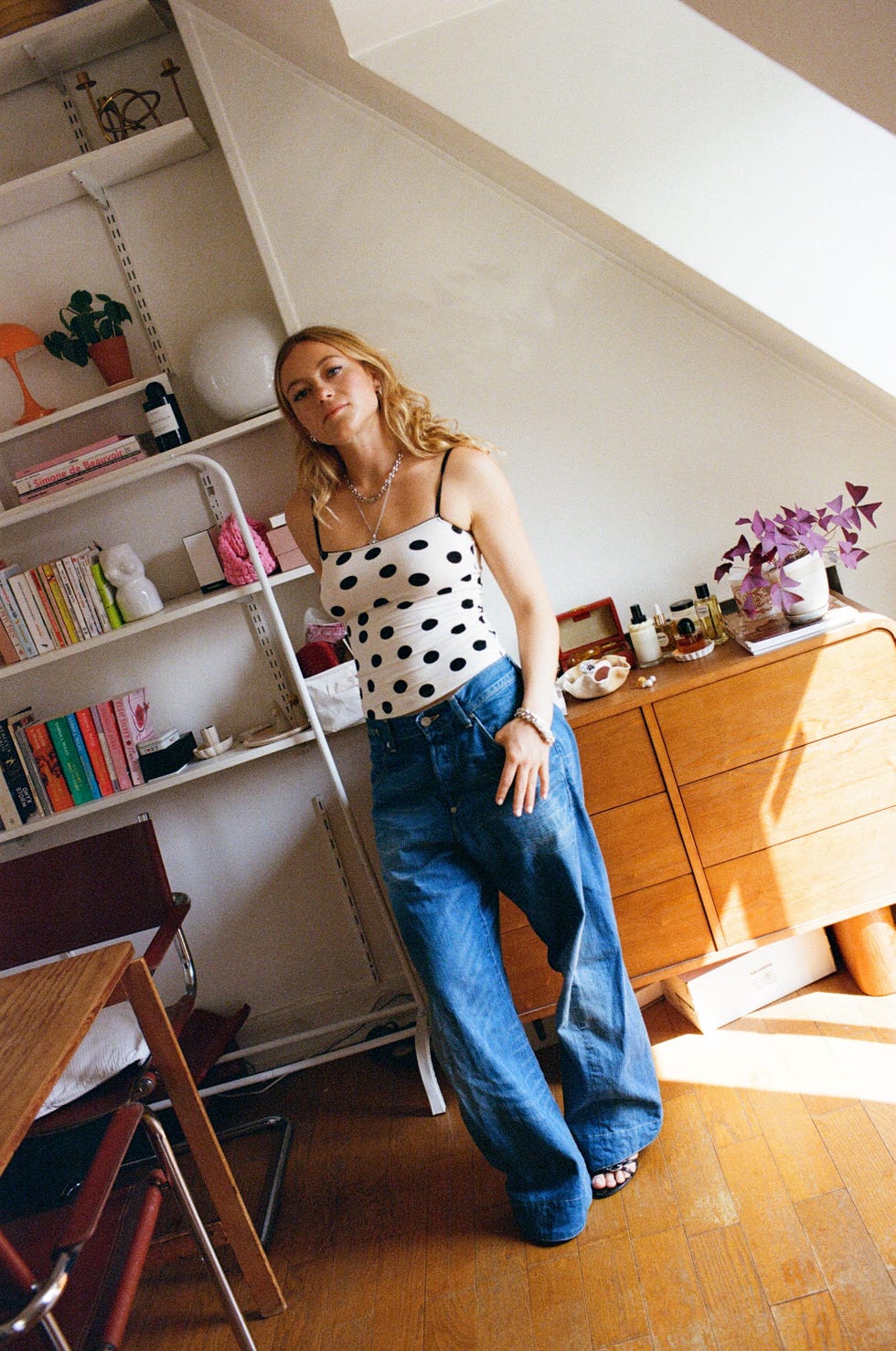 person standing in a stylish room with furniture and decor items