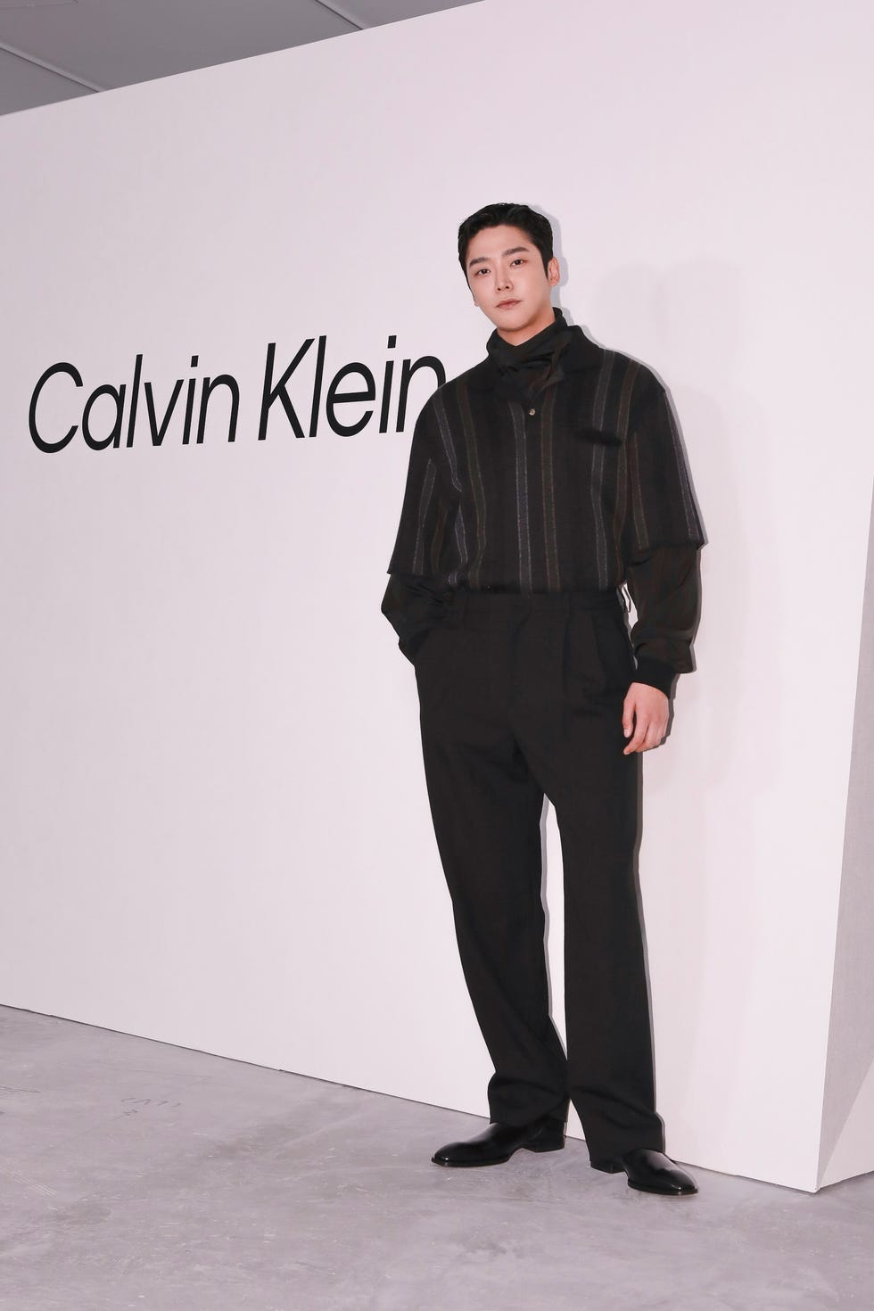 model posing at a fashion event featuring calvin klein branding