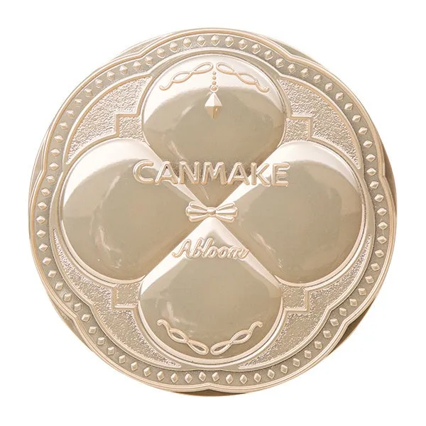 CANMAKEのAbloomという化粧品のパッケージの画像です。金色で丸い形をしており、四つ葉のクローバーのようなデザインが特徴です。