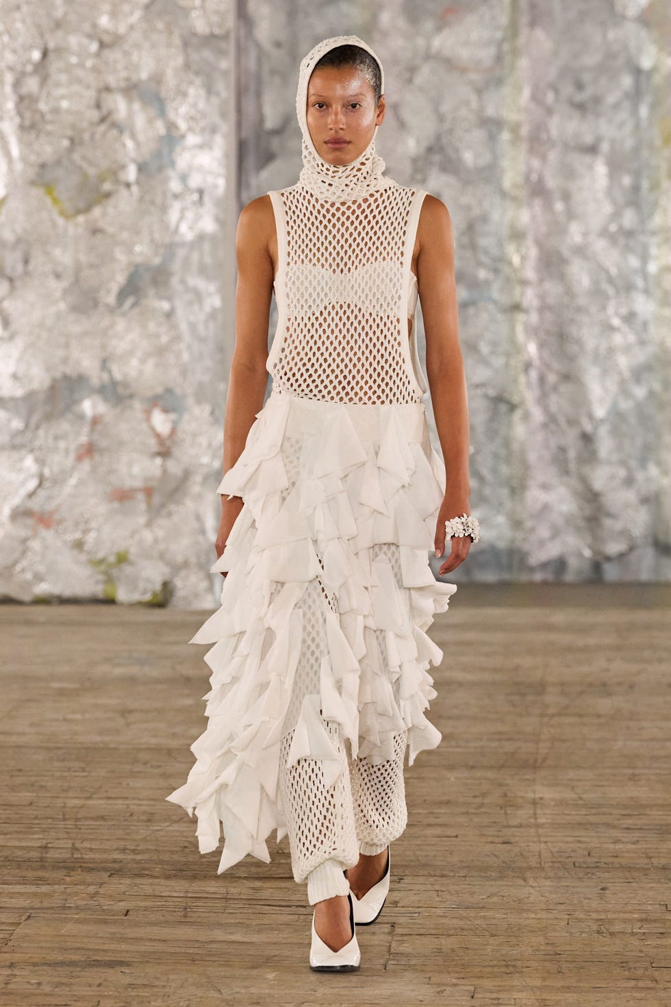 fashion model showcasing an avantgarde outfit with a layered design