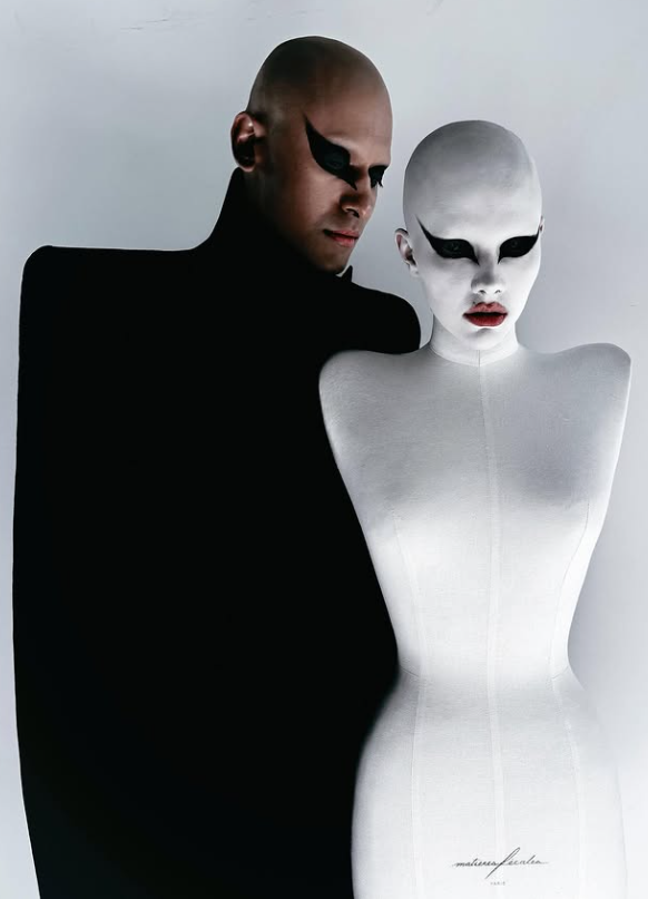 two figures one in a dark garment and the other a mannequin highlighting fashion and design