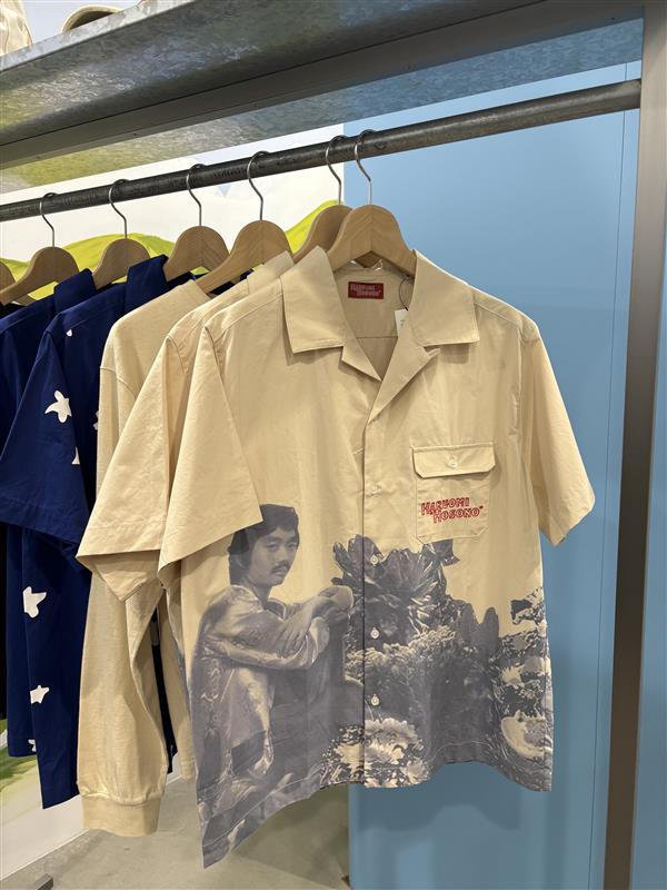 shortsleeved collared shirt featuring a graphic design