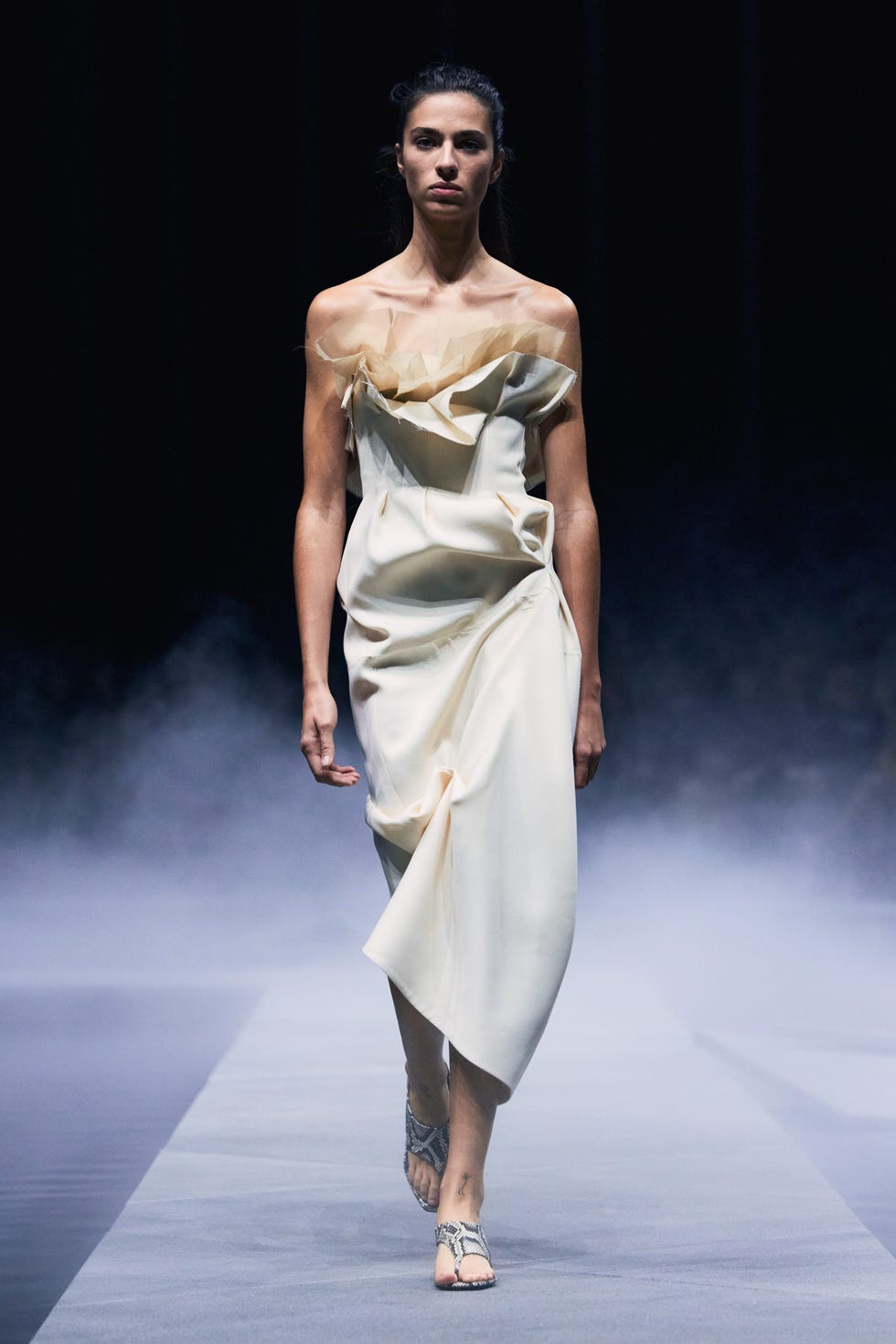 model walking on runway in a minimalistic fashion design