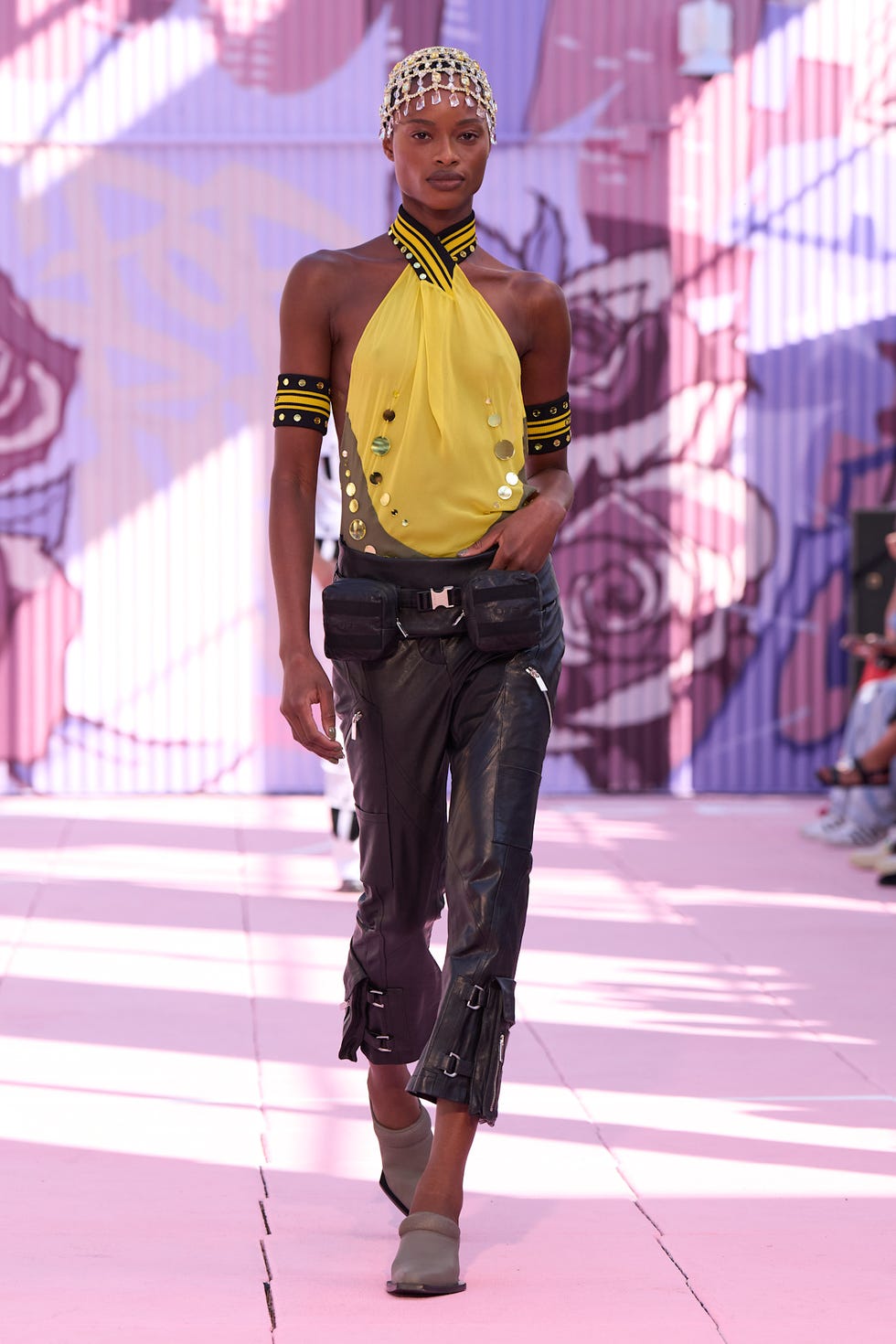fashion model walking on a runway wearing a bold outfit