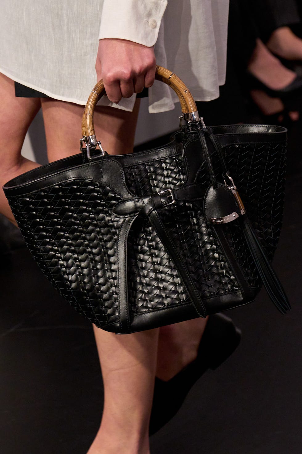 fashionable black handbag with bamboo handle