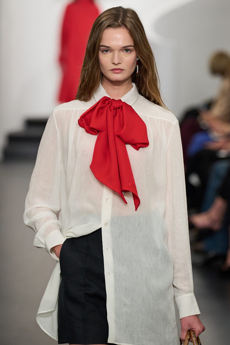 fashion model wearing a stylish outfit with a prominent red bow tie