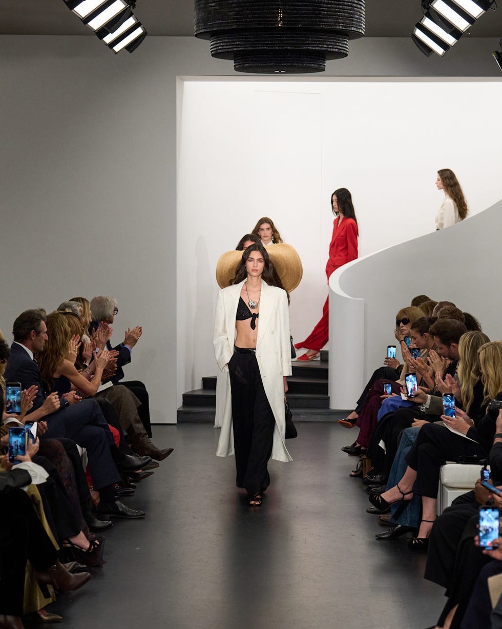 fashion runway featuring models in diverse outfits with an audience observing