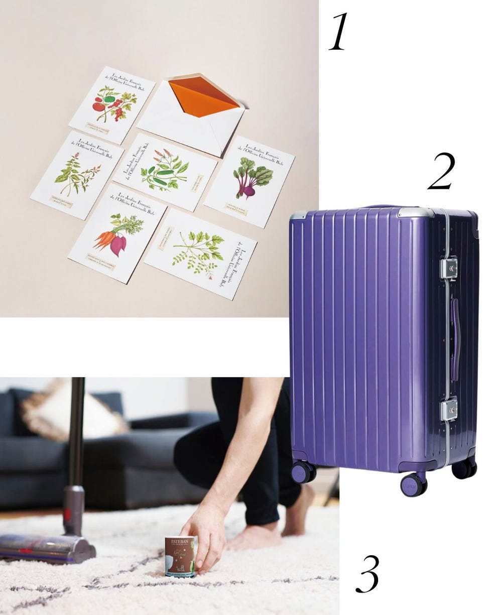 stationery items a suitcase and a person picking up an object from a carpet