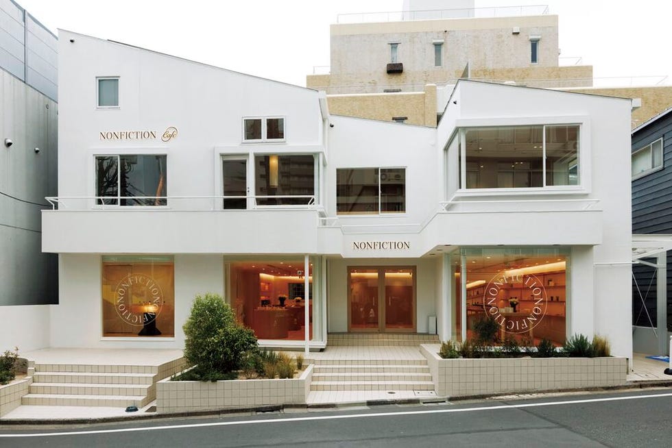 modern cafe building with large windows and stylized signage