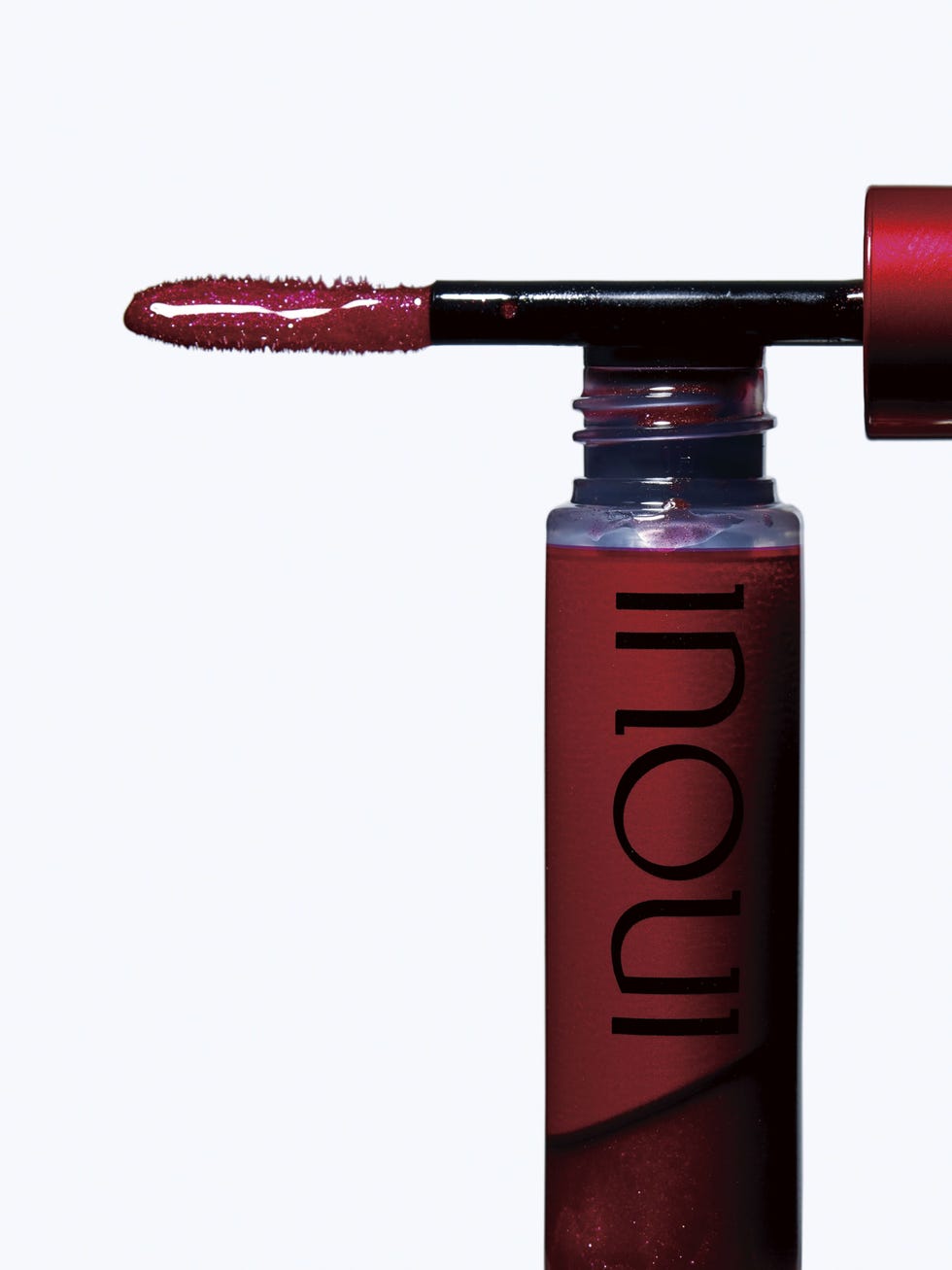 liquid lipstick applicator and bottle showcasing a rich red shade