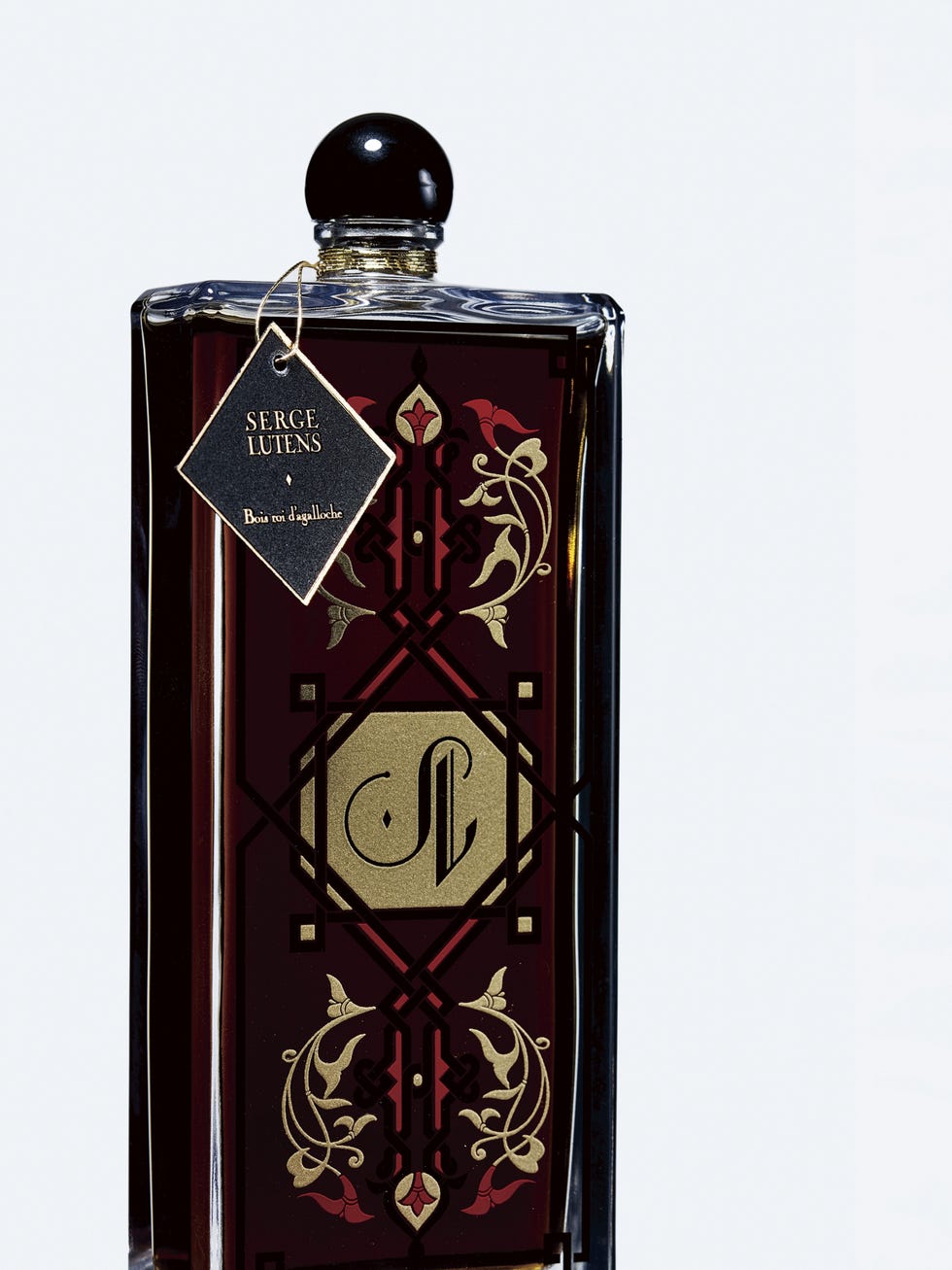 fragrance bottle with ornate design and label