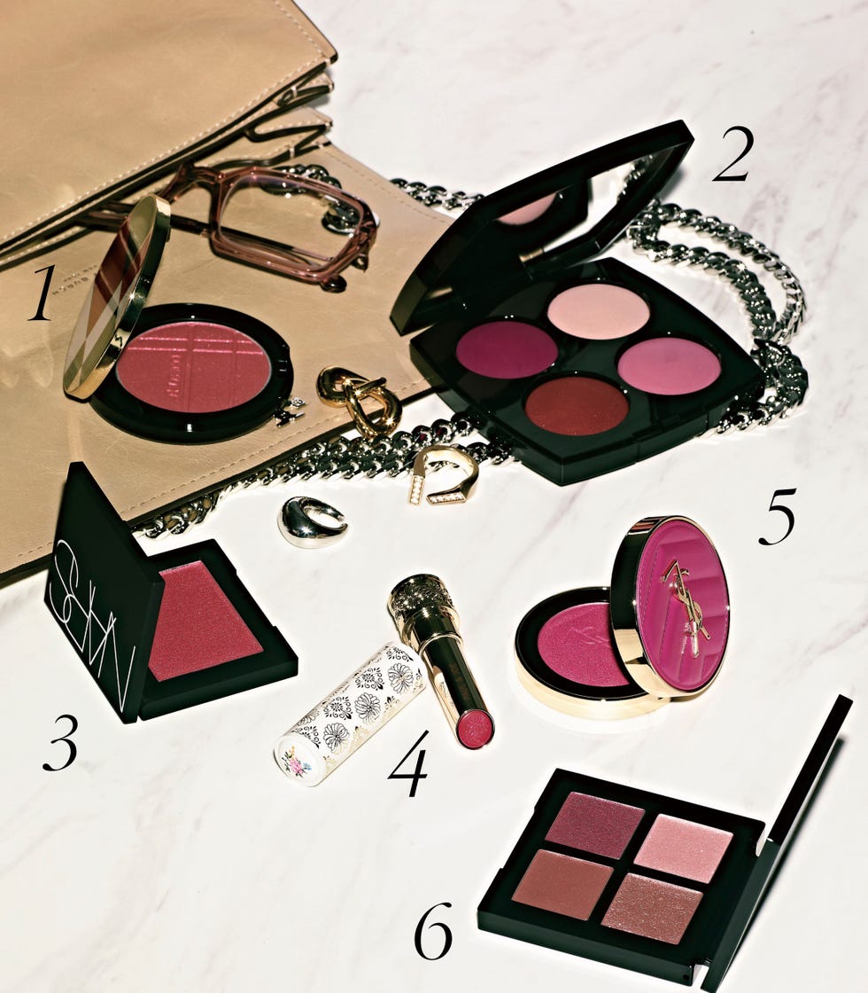 a collection of makeup products arranged on a surface