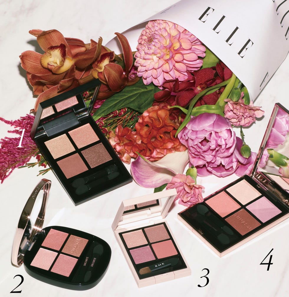 collection of eyeshadow palettes surrounded by flowers