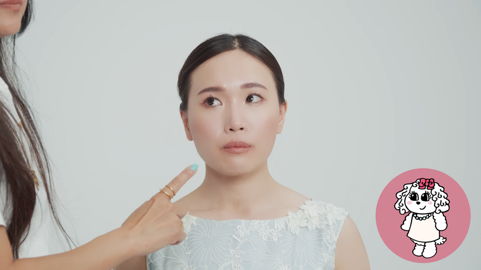 a woman demonstrating a beauty tutorial with a model