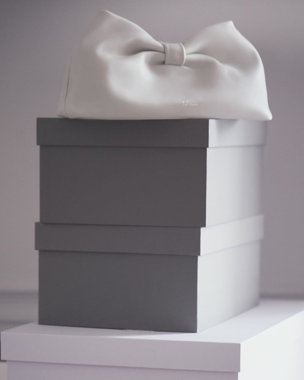 designer handbag atop stacked boxes