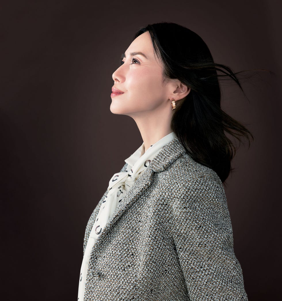 a side profile portrait of a woman with blurred facial features displaying confidence