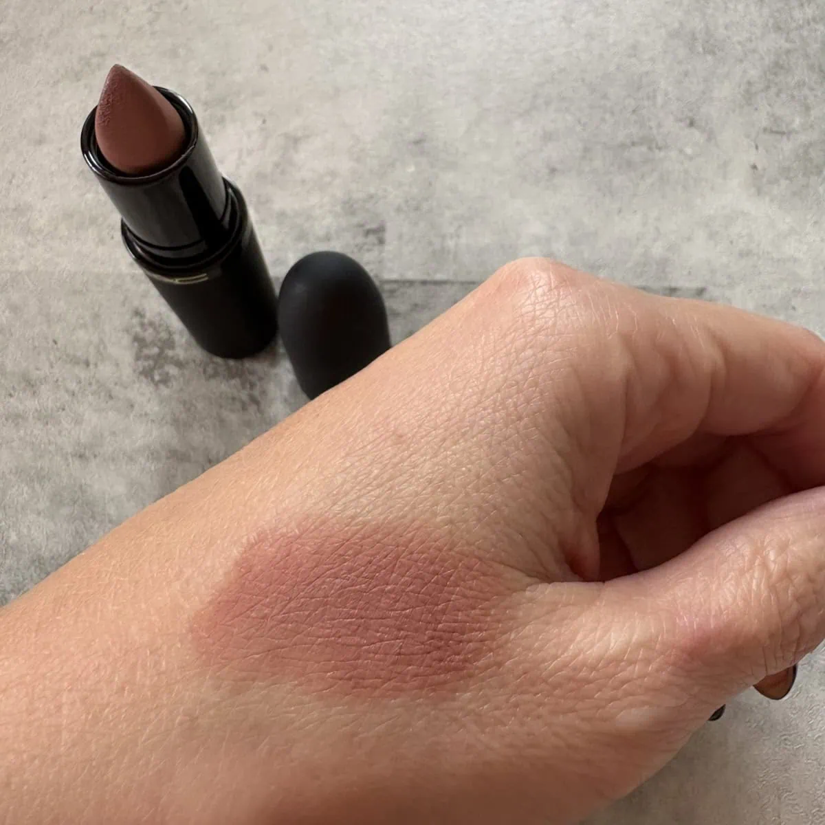 M·A·C パウダー キス ヘイジー マット リップスティック「テイケン」のスウォッチ。90年代ムードのヌードカラー