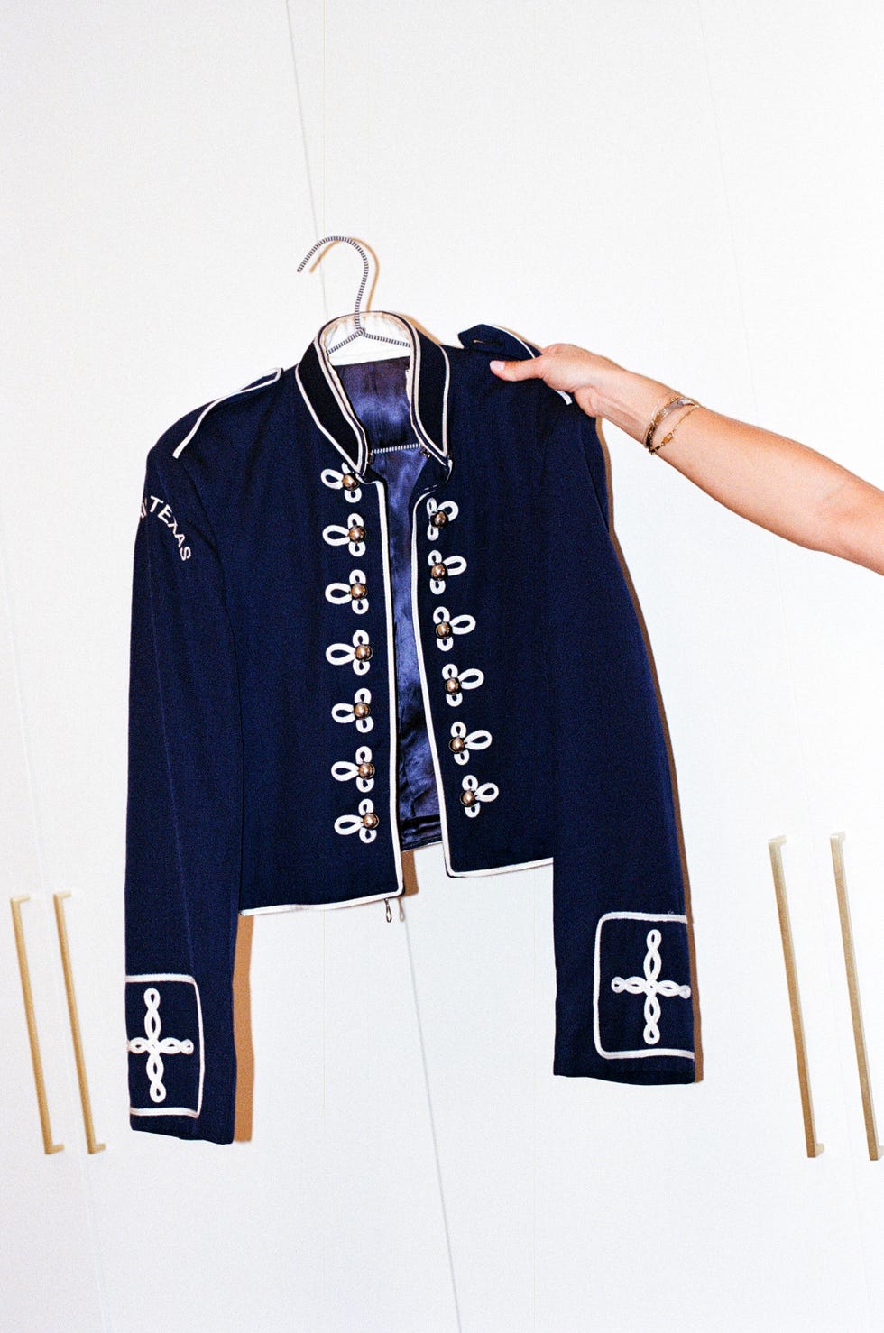 navy blue militarystyle jacket with decorative buttons and embellishments