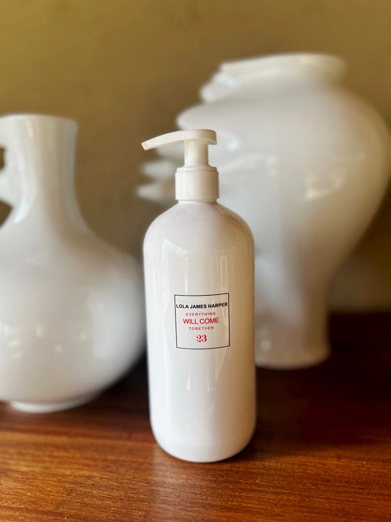 a white lotion bottle with a pump dispenser and decorative vases in the background
