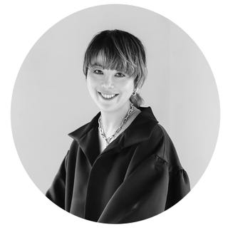 portrait of a person wearing a stylish black outfit and jewelry