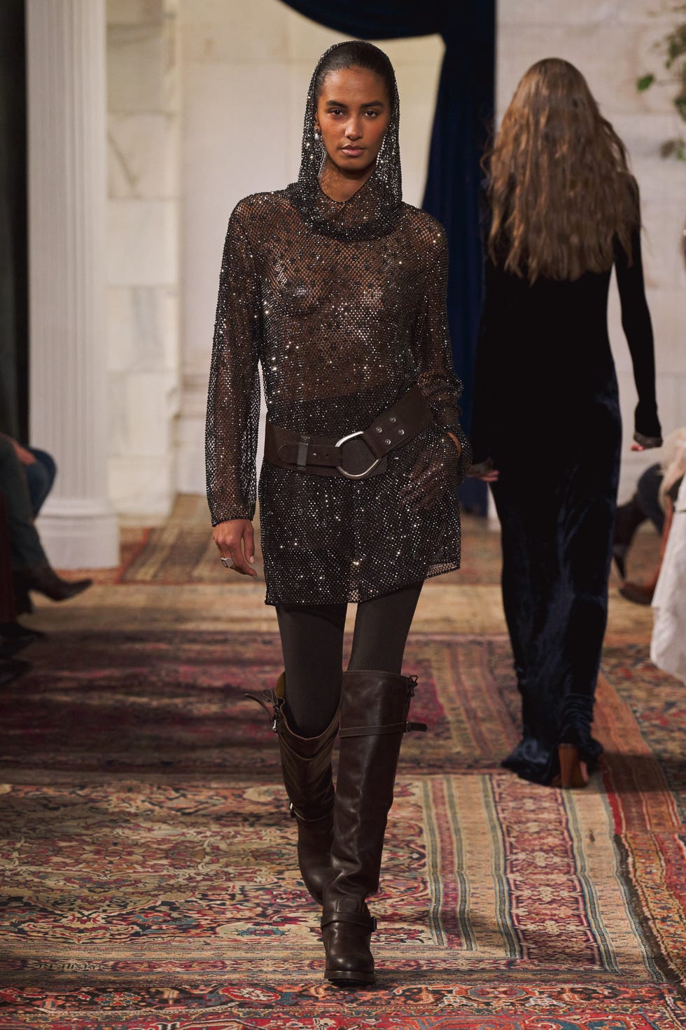 model wearing stylish outfit on a runway