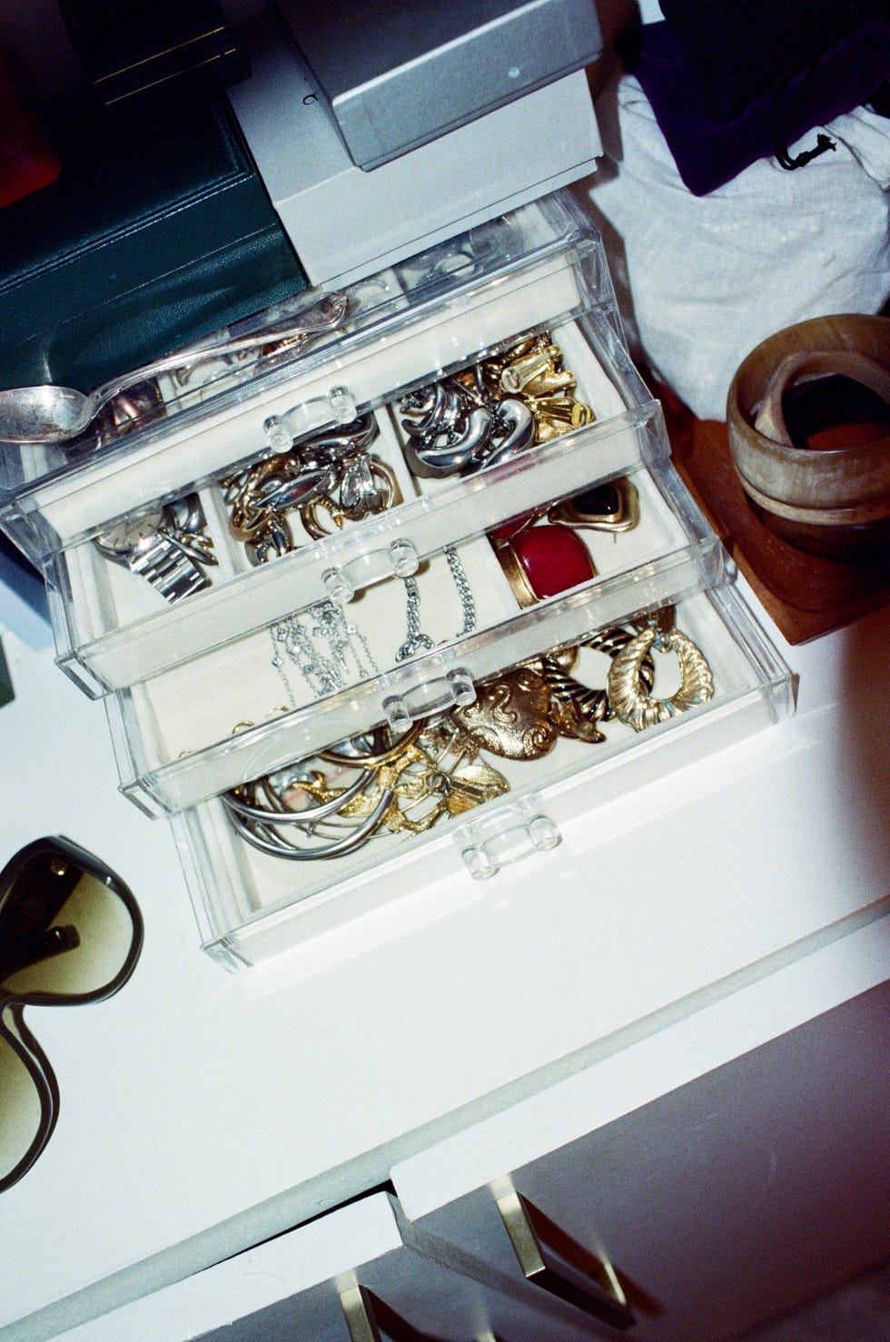 jewelry organizer with various pieces inside on a dresser