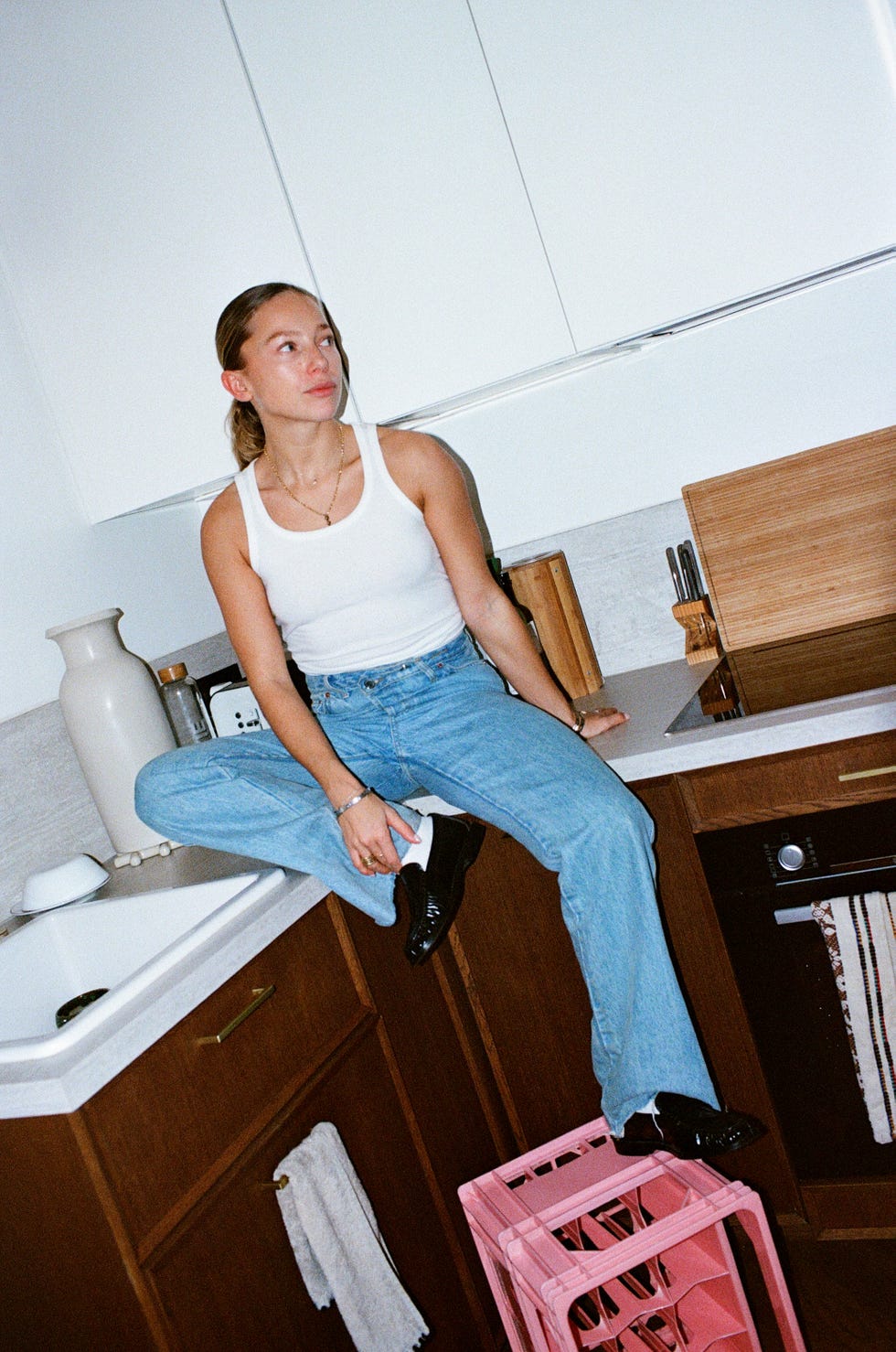 person seated on a kitchen countertop