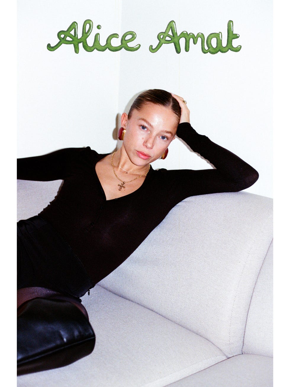 person seated on a light gray couch styled with text overhead