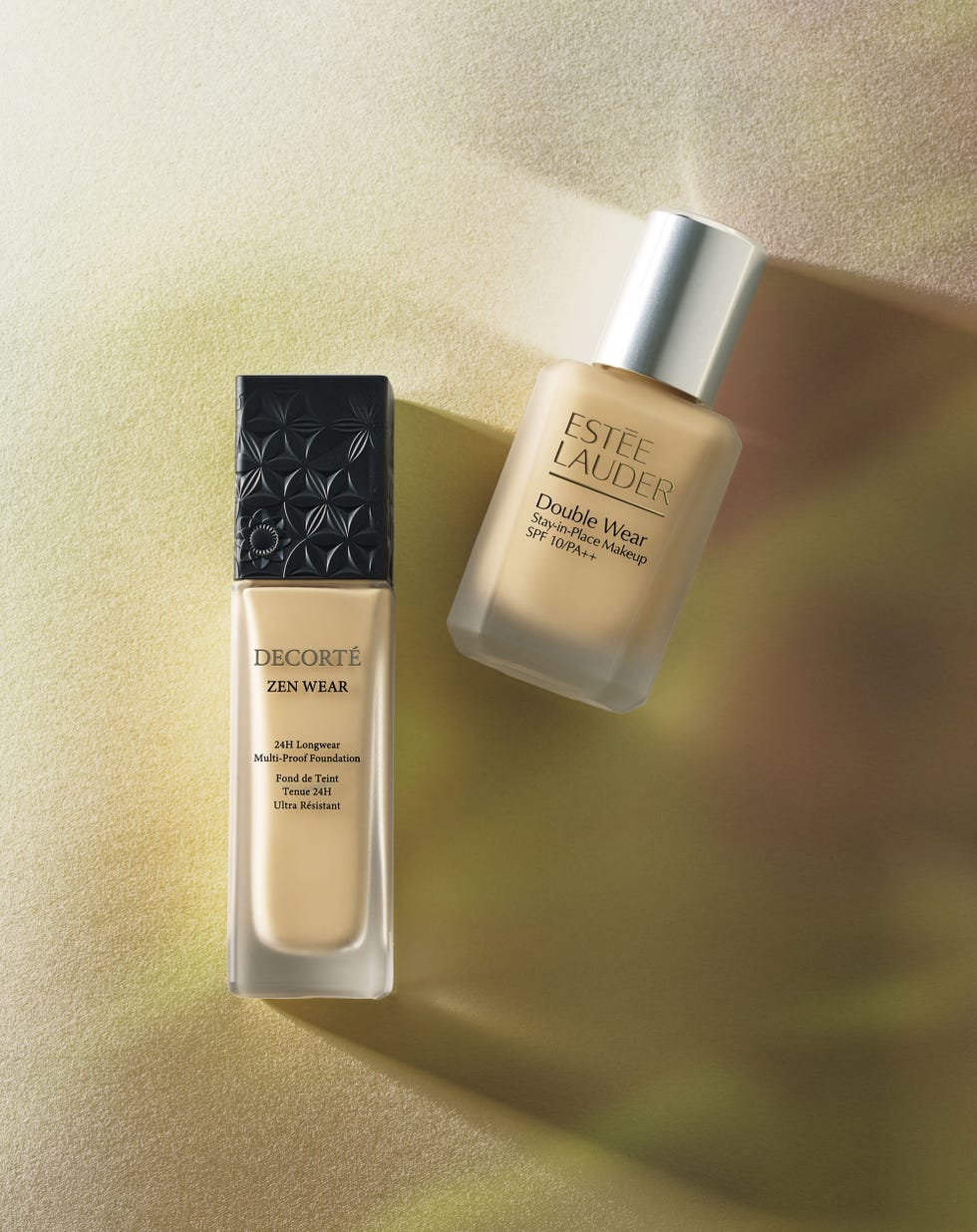 two foundation bottles on a gradient background