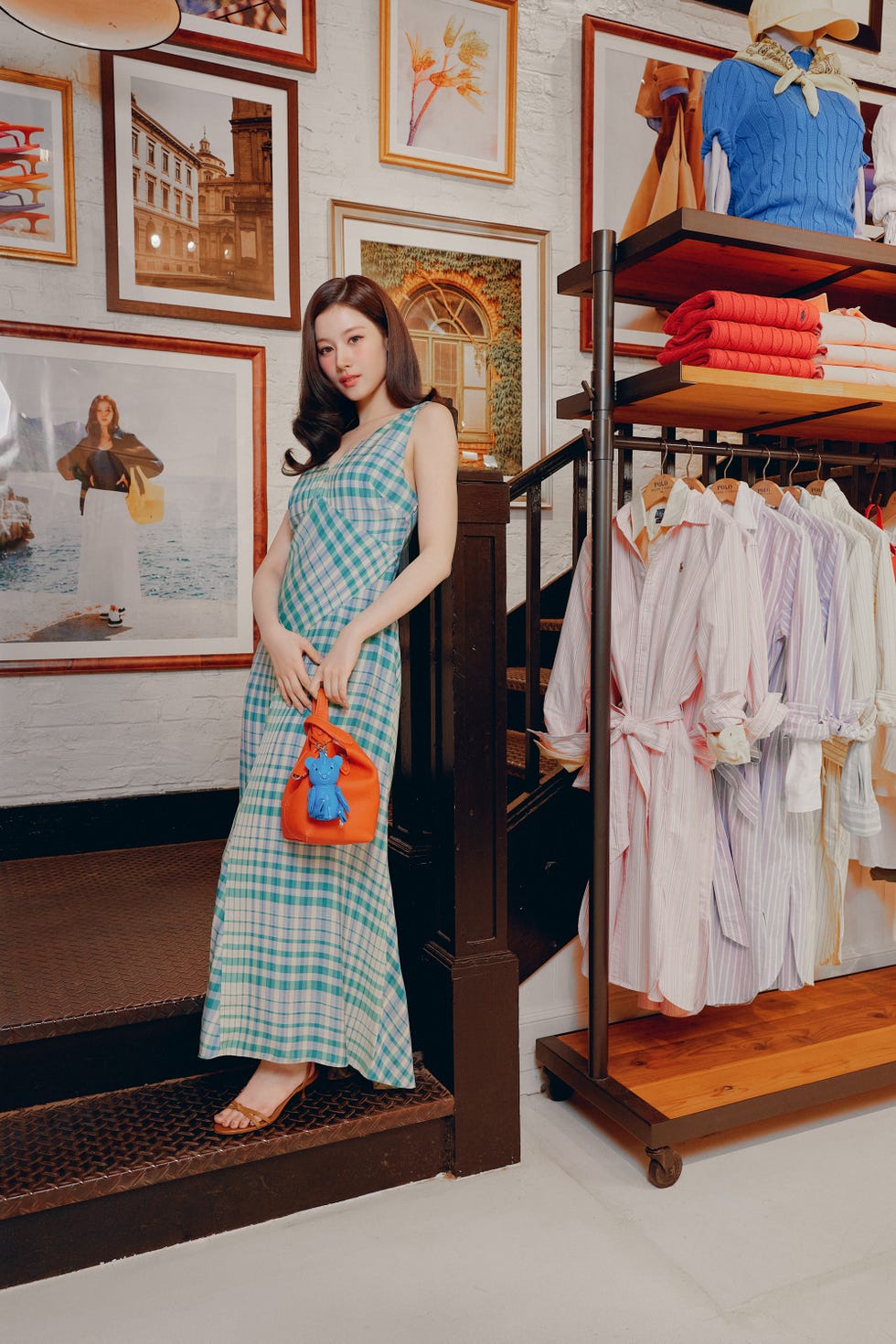 woman wearing a checkered dress holding an orange purse woman wearing a checkered dress holding an orange purse