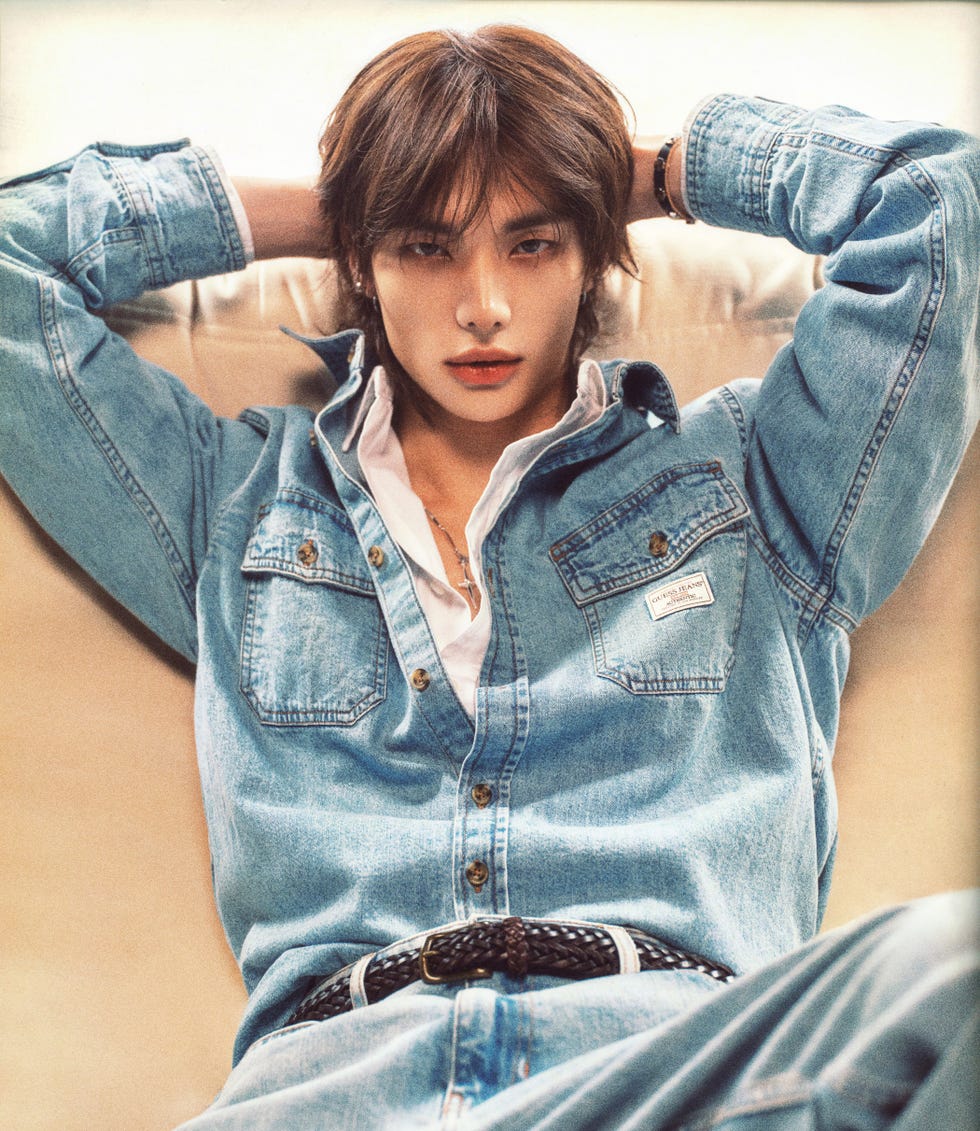 individual relaxing on a couch in denim attire