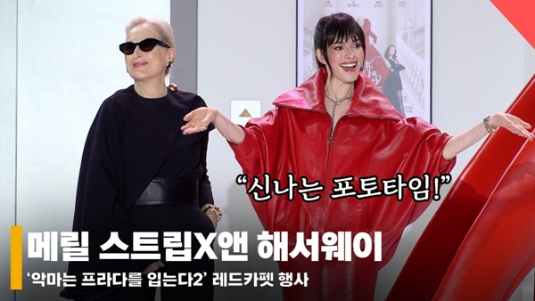 「悪魔はプラダを着る」広報イベントに参加したメリル·ストリームとアン·ヘサウェイの写真を展示するユン記者 