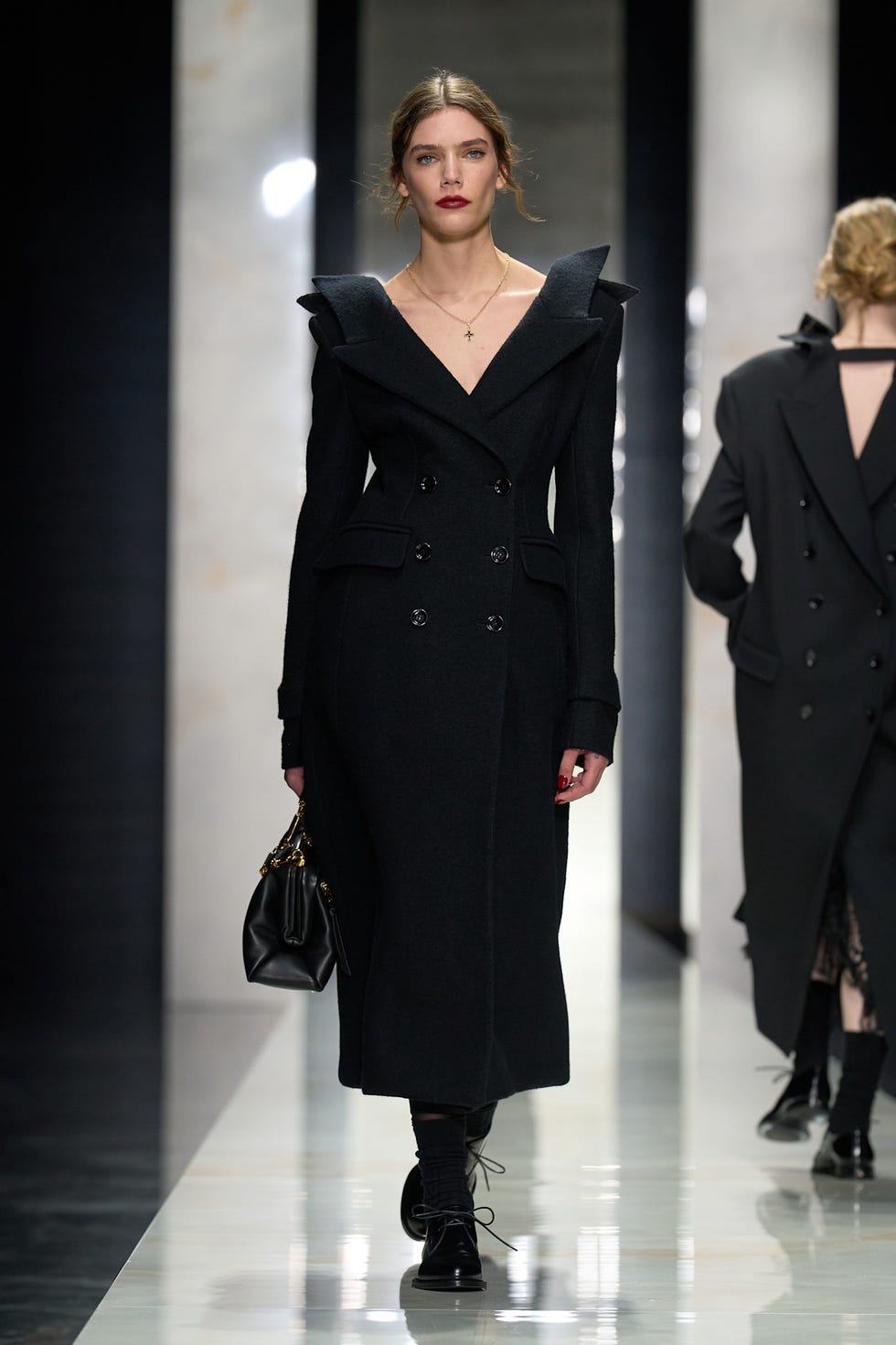 model showcasing a fashion piece on the runway