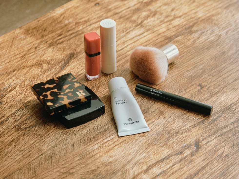 assorted makeup products on a wooden table assorted makeup products on a wooden table